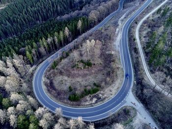 High angle view of vehicles on road amidst trees