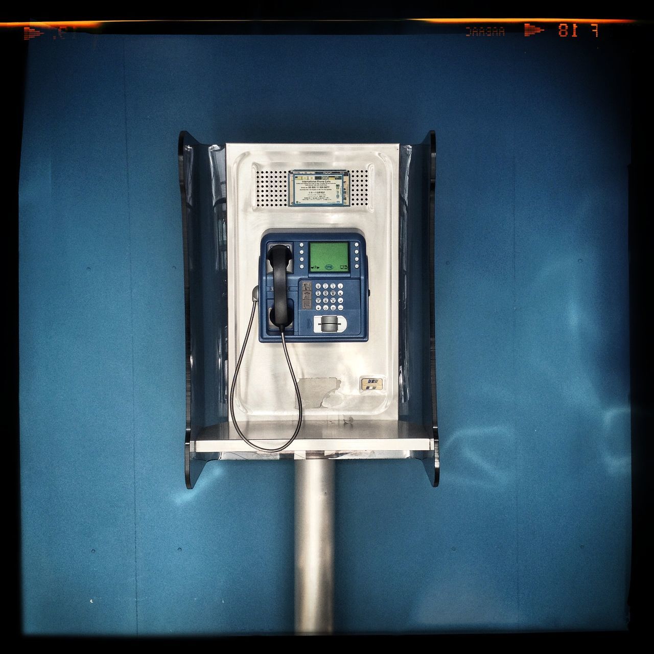 CLOSE-UP OF TELEPHONE BOOTH IN ROOM