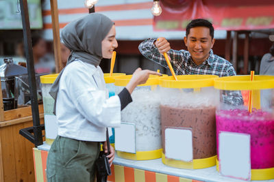 Side view of young woman drinking water