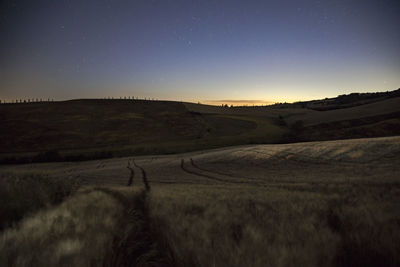 Scenic view of landscape against sky at night