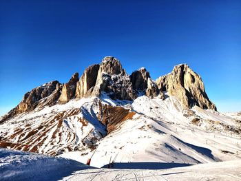Scenic view of snowcapped mountains against clear blue sky
