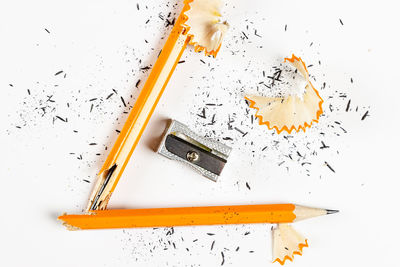 High angle view of colored pencils against white background