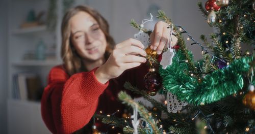 Cropped hand holding christmas tree