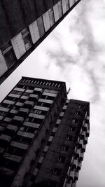 Low angle view of building against cloudy sky