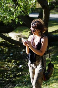 Woman using mobile phone at park