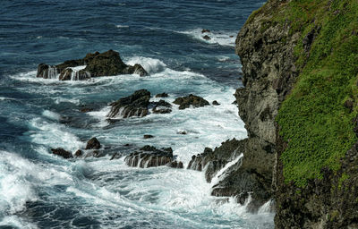 Rocks on shore by sea