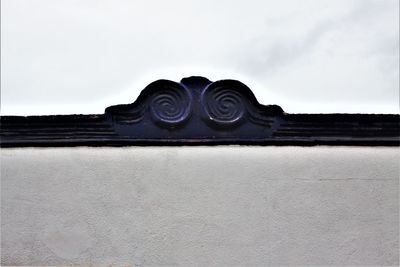 Low angle view of building against cloudy sky