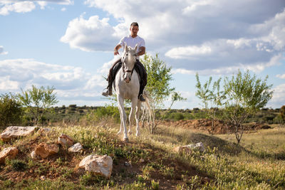 View of horse riding on field