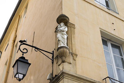 Center of aix en provence, on the corners of buildings are saints of the catholic religion.