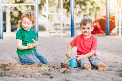 Boys playing with sand at park