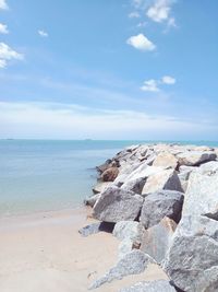 Rocks on beach against sky