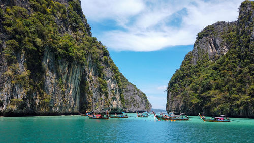 Panoramic view of boats in sea against sky