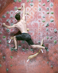 Man bouldering at indoor gym in england