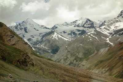 Scenic view of mountains against cloudy sky