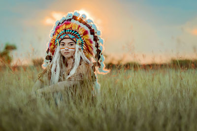 Portrait of woman wearing hat on field against sky