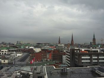 Cityscape against cloudy sky