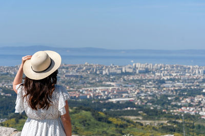 Rear view of woman standing on hill at klis fortress above city of split in croatia