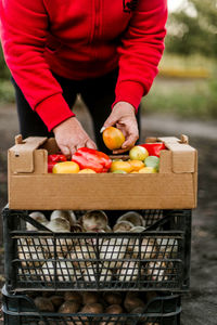 Midsection of woman holding small shopping cart