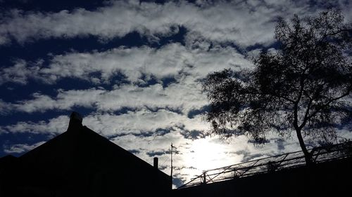 Low angle view of silhouette trees against sky