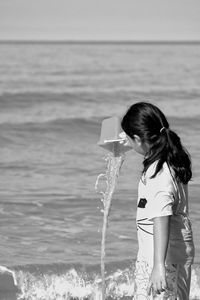 Girl pouring at beach