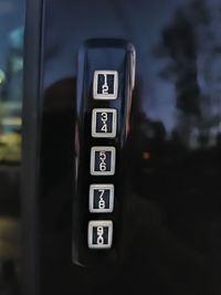 Close-up of information sign on car at night