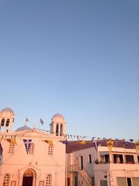 Low angle view of buildings against clear blue sky