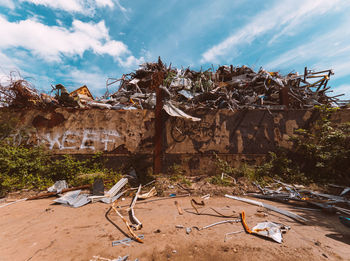 Low angle view of garbage against sky during sunny day