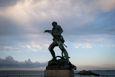 Low angle view of statue against sky during sunset