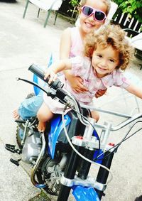 Portrait of happy young woman riding bicycle