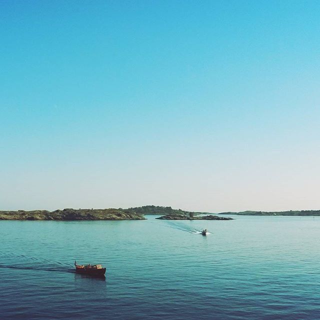 water, clear sky, nautical vessel, copy space, transportation, mode of transport, boat, waterfront, sea, blue, tranquility, tranquil scene, scenics, beauty in nature, nature, sailing, rippled, idyllic, travel, outdoors