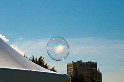 Low angle view of bubbles against sky