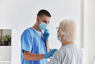 Female doctor examining patient at clinic