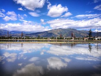 Scenic view of lake against cloudy sky