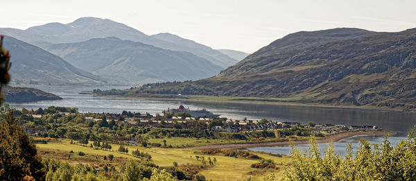 Scenic view of lake and mountains against sky