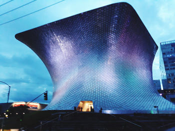 Low angle view of illuminated buildings against sky