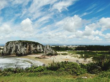 Scenic view of river against cloudy sky