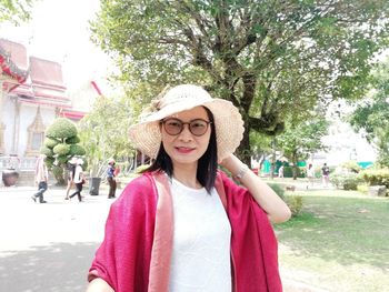 Portrait of woman against pink trees