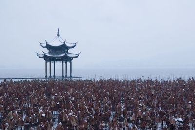 Panoramic view of crowd in sea against sky