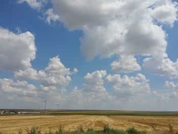 Scenic view of field against cloudy sky