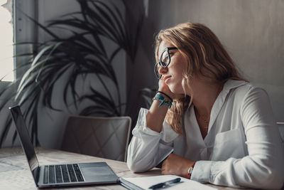 Young woman using laptop at home