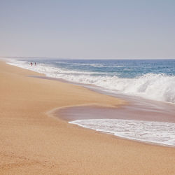 Scenic view of beach against clear sky