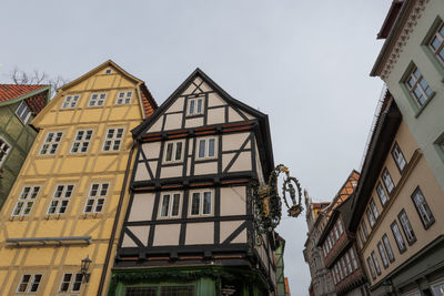 Low angle view of buildings in town against sky