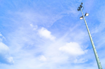 Low angle view of floodlights against sky