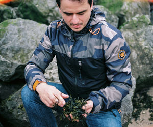 High angle view of man holding rock