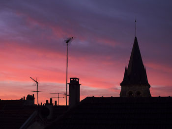 Low angle view of building against sky at sunset