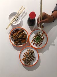 Cropped hand of woman having food at table