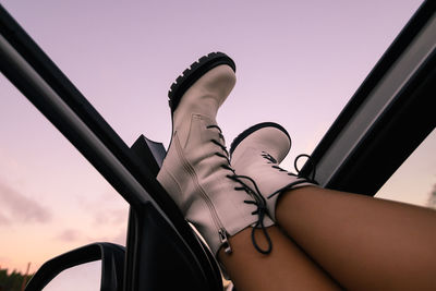 Low angle view of woman standing against sky