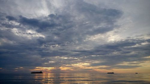 Scenic view of sea against cloudy sky