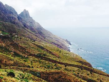 Scenic view of sea and mountains against sky