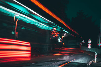 Light trails on road in city at night